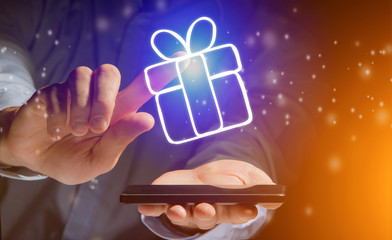 View of a Hand of a man holding smartphone with christmas icons all around