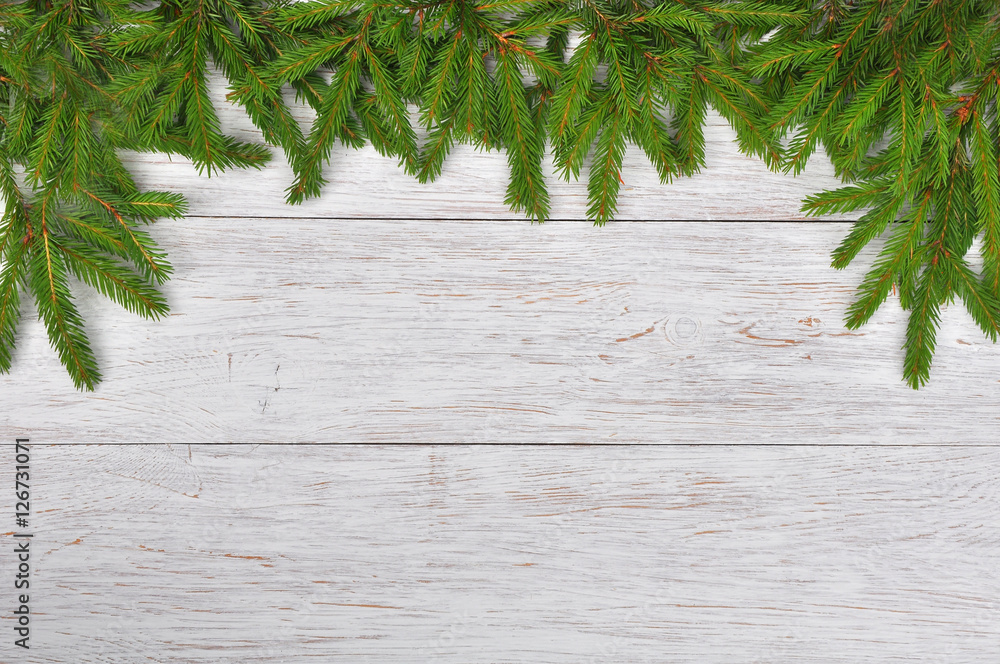 Wall mural christmas background with fir branches on a white wooden backgro