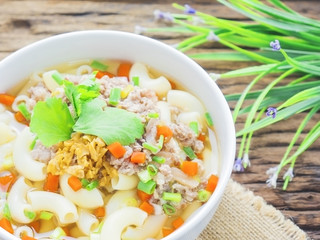 Macaroni soup putting on sack cloth and wooden background