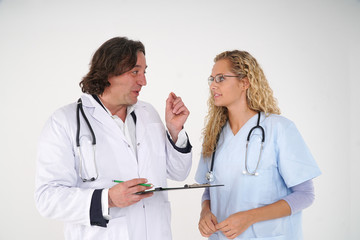 Fototapeta premium Senior doctor and young beautiful nurse