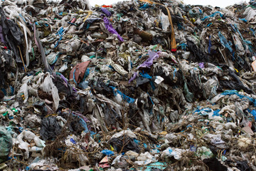 Pile of plastic bags and other refined petroleum products dumped in landfill. Garbage heap gives infiltrate into ground. Waste sorting is required. Lviv city