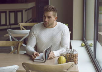 Man with book in cafe