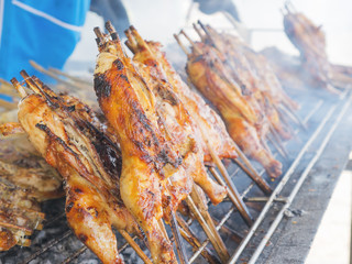 Asian style grilled chicken on screen and hot charcoal