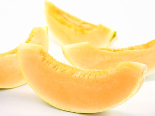 Selective focus of slice cantaloupe isolated over white
