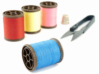 Thimble,spools, scissors isolated over white background