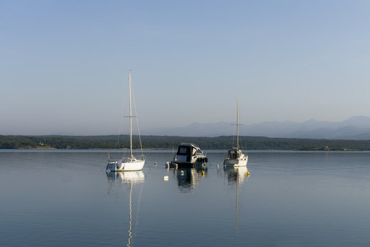 Anchored boats in bay in the morning
