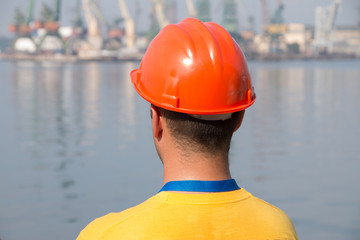 Harbour docker worker waiting for a ship, sea waves in background