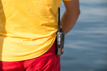 Harbour docker worker waiting for a ship, sea waves in background
