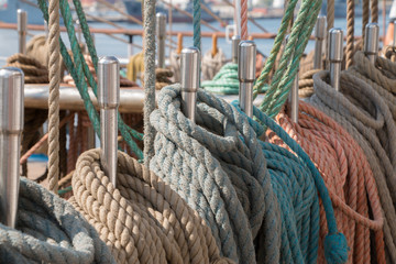 Deck and ropes, rigging on a wooden tall ship sail yacht. Close up view