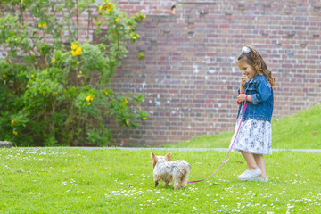 outdoor portrait of young happy smiling child girl playing with