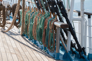 Deck and ropes, rigging on a wooden tall ship sail yacht. Close up view