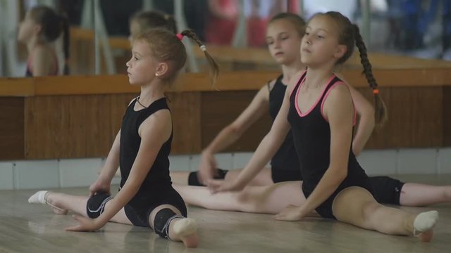 Young artistic gymnast training in the gym
