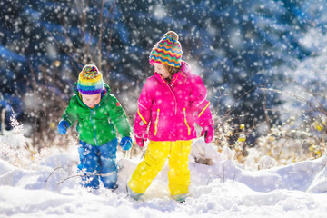 Children playing in snowy winter park