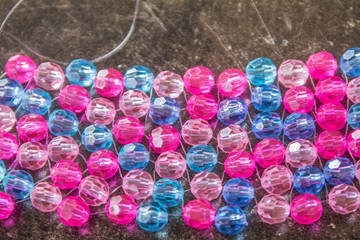 colorful background made of beads lit in the sun light