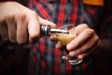 bartender pours a cocktail b 52 close-up