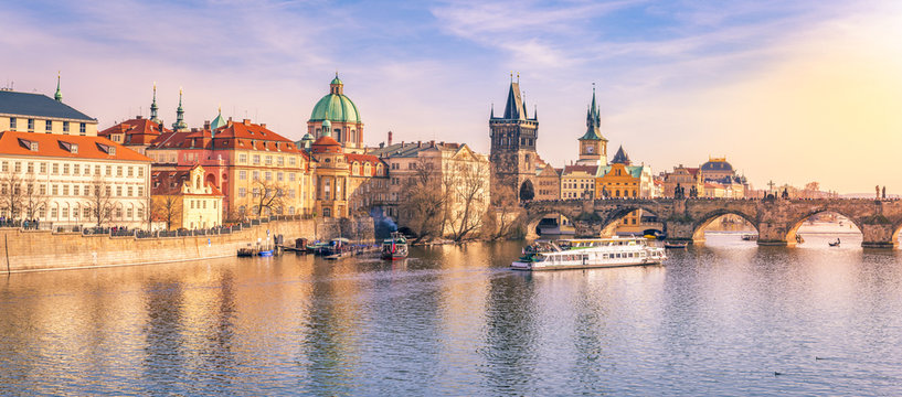 Prague panorama with its river and buildings - Panorama of Prague city, the capital of Czech Republic, with the Vltava river, the Charles Bridge and  surrounding buildings, on a sunny day of March.