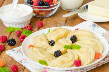 Homemade dumplings (vareniki) with cottage cheese and berries. Traditional Ukrainian and Russian dish.