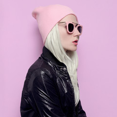 Glamorous blonde in fashionable hat beanie and pink glasses Vani