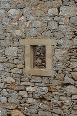 Fototapeta na wymiar Old stone window in ruins on the Greek island of Crete