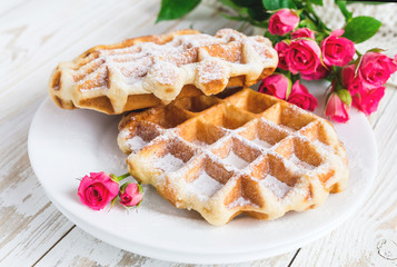 Warm knitted plaid, pink roses and Belgium waffles