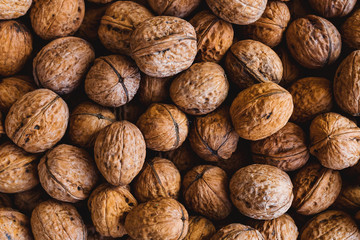 Whole walnuts background. Close up, top view.