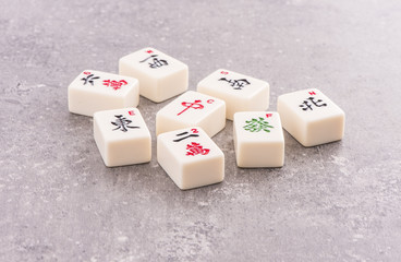 Mahjong board game pieces lying on stone table. Concept of asian or chinese leisure activity, recreation and traditional games. - 126749697