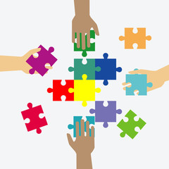 Naklejka premium Four hands putting multicolor puzzle pieces together. Teamwork, cooperation, business, solution, work concept.