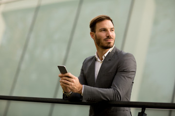 Fototapeta premium Young bisinessman with mobile phone