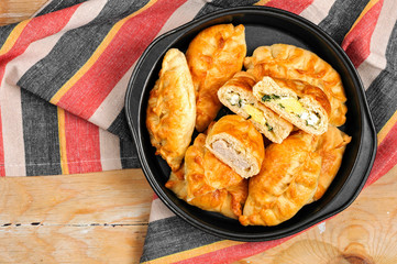 Russian pirozhki baked patties with meat and eggs
