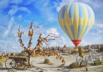 Colorful hot air balloon flying over the valley at Cappadocia, Turkey. Volcanic mountains in Goreme...