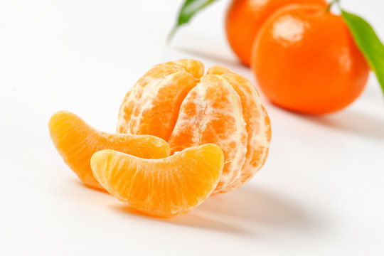 peeled and unpeeled tangerines