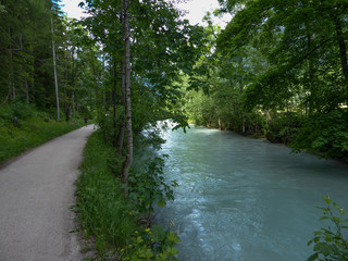 A slowly blue stream and trees on both sides