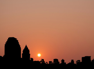 City / Silhouette of city at sunset. Digital retouch.