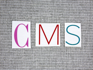 CMS (Content Management System) acronym on grey background