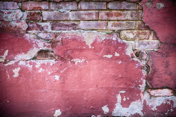 Obraz premium Decaying wall grunge texture. Red paint and exposed brick with plaster falling off