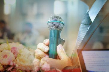blurred of businessman speech with microphone in meeting room at