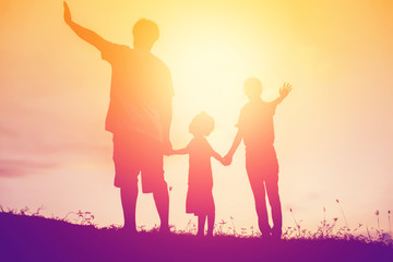 silhouette of a happy family and happy time sunset