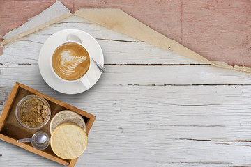 Coffee Latte Art cup on wooden table background, top view 