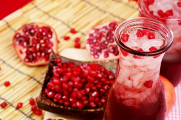 Pomegranate juice set on wooden mat background