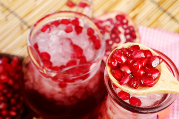 Pomegranate juice set on wooden mat background