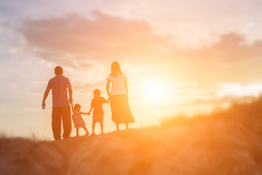 Happy Family Dancing On The Road In The Sunset Time. Evening Par