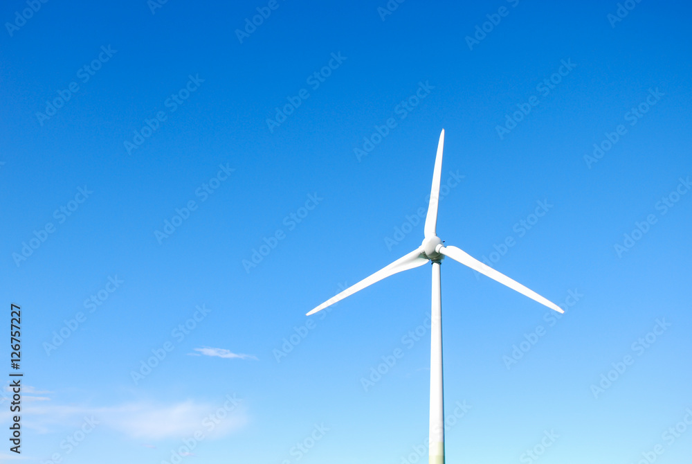 Wall mural windmill by a bright blue sky