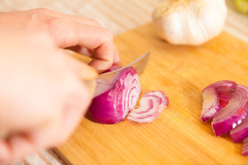 cropped onion with other vegetables on a cutting board