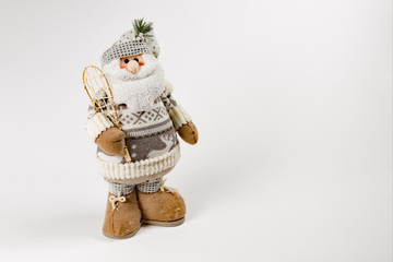 Santa Clause statue soft with snow shoe on white background framed left