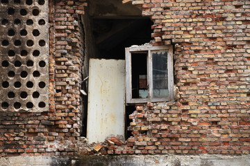 Old destroyed window on brick wall in Sarajevo , Bosnia and Herzegovina