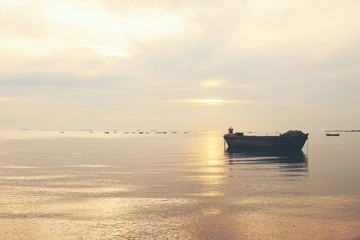 old boat in front of sunset background