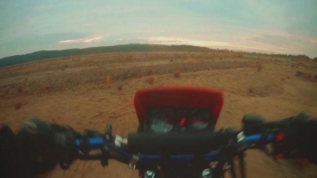 Enduro rider in motorcycle riding on dirt track
