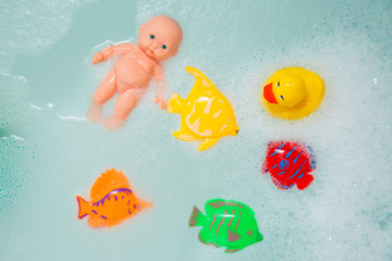 Bath toys in white foam bubbles