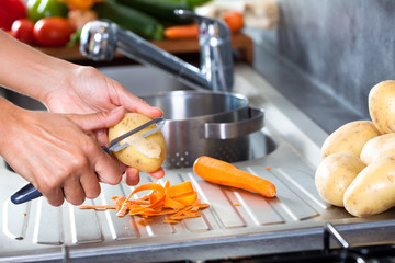 éplucher des pommes de terre et des carottes