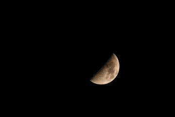 Moon over dark black sky at night